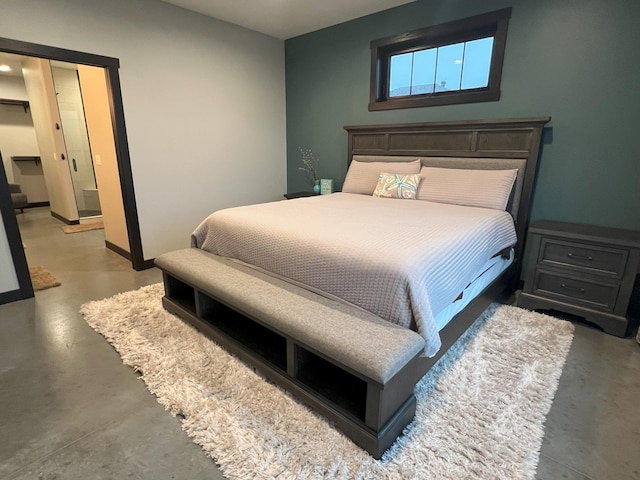 bedroom featuring baseboards and finished concrete floors