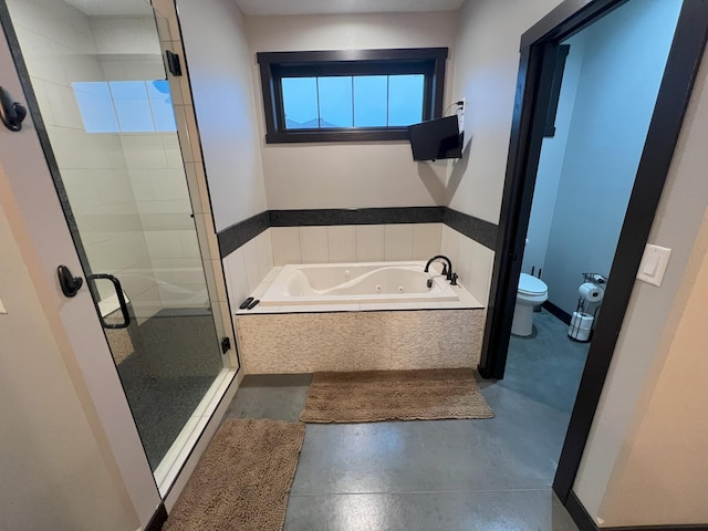 full bathroom featuring toilet, a tub with jets, and a stall shower