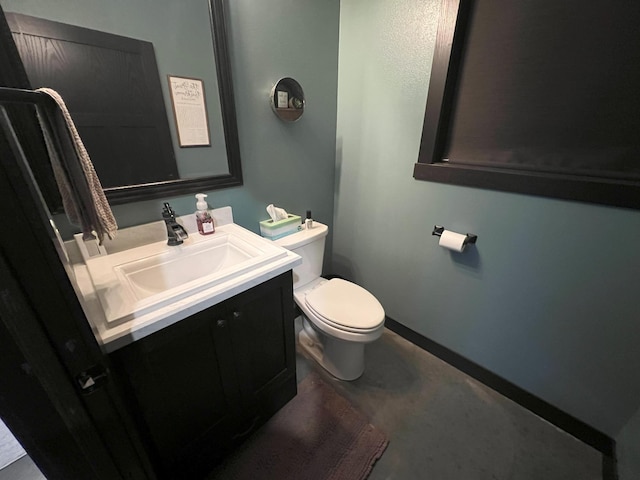 bathroom featuring toilet and vanity