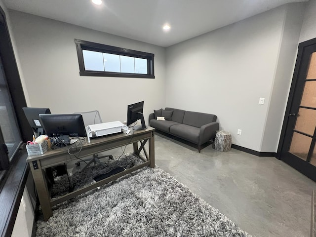 office space featuring recessed lighting, baseboards, and concrete floors