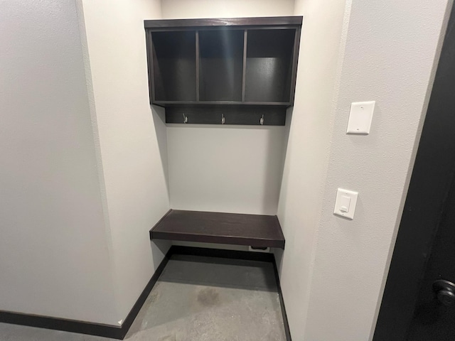 interior space with baseboards and unfinished concrete floors