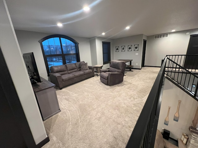 living area with recessed lighting, visible vents, carpet flooring, and stairway