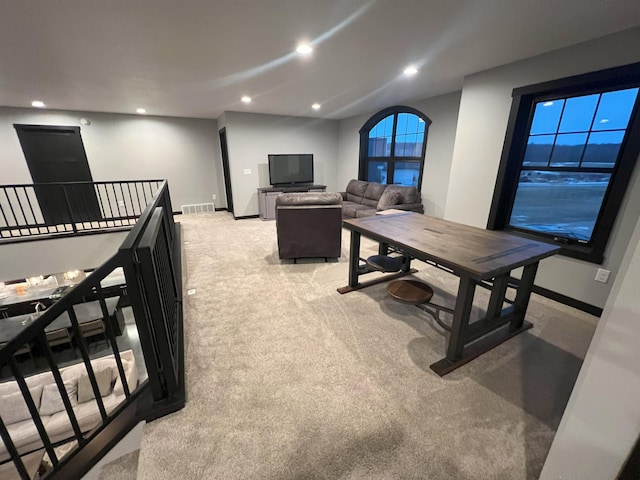 interior space featuring recessed lighting, visible vents, light carpet, and baseboards