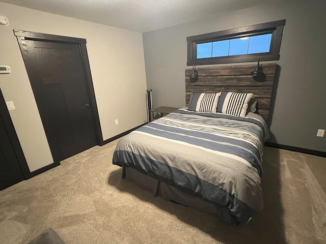 carpeted bedroom with baseboards