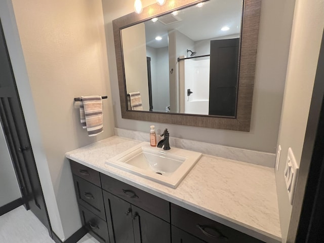 bathroom with a shower and vanity