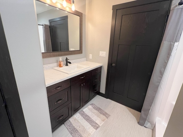 full bathroom featuring tile patterned floors and vanity