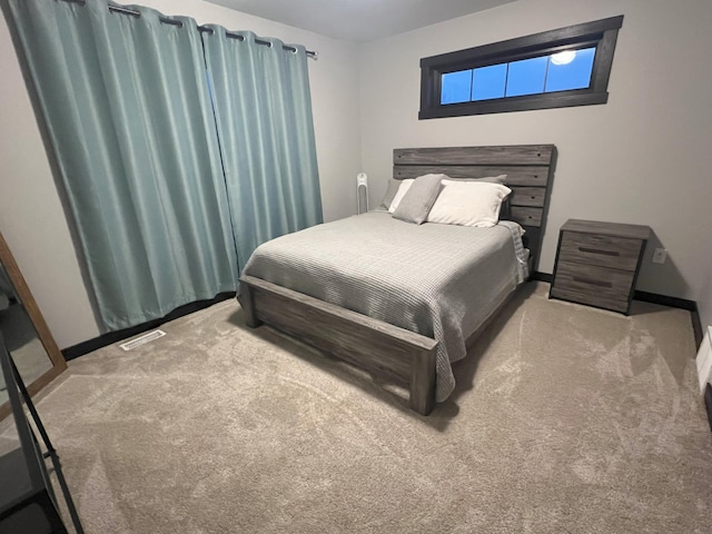 carpeted bedroom with baseboards and visible vents