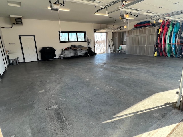 garage with a sink and a garage door opener