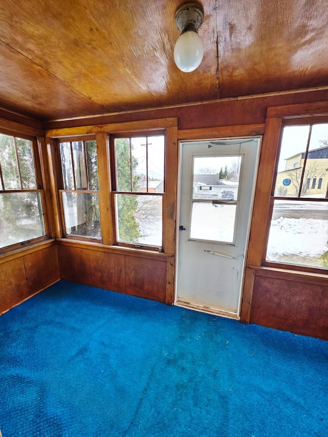 unfurnished sunroom featuring wooden ceiling