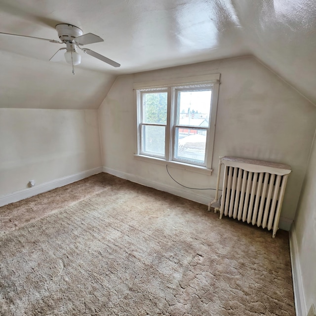 bonus room with baseboards, carpet flooring, vaulted ceiling, and radiator heating unit