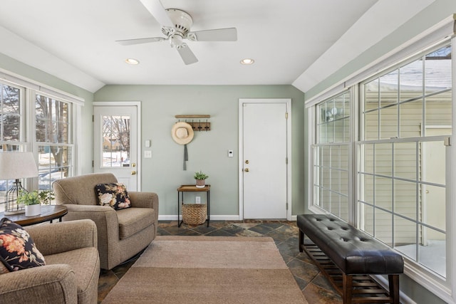 living room with stone tile floors, recessed lighting, baseboards, and vaulted ceiling