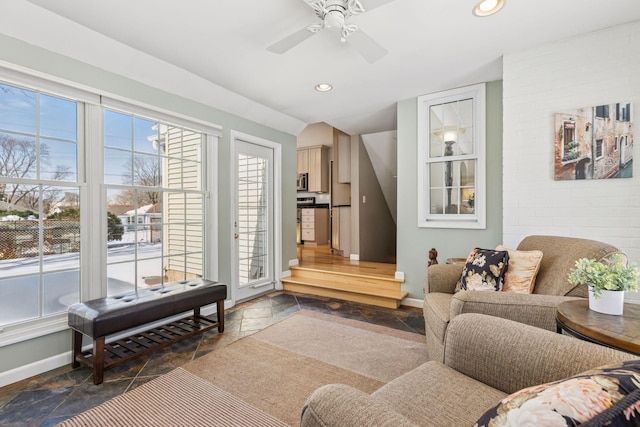 interior space with stone tile floors, a healthy amount of sunlight, and baseboards