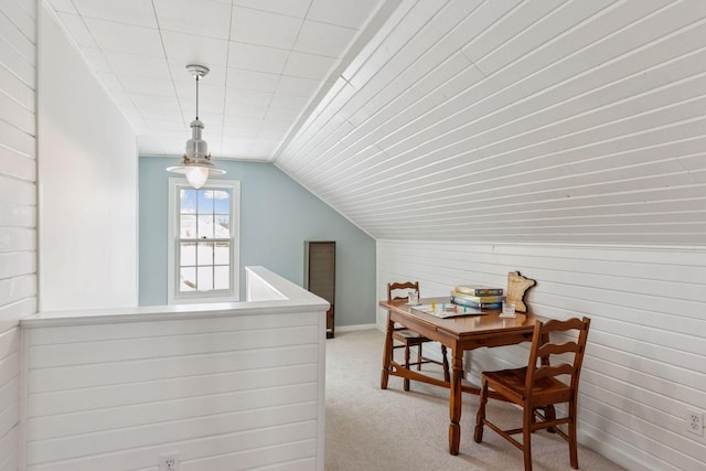 dining area with light colored carpet and vaulted ceiling