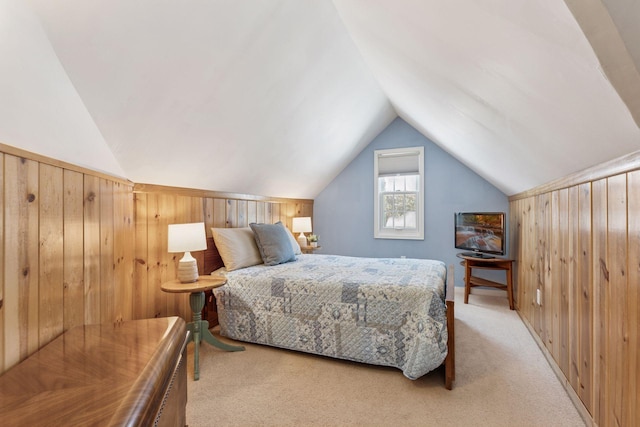 bedroom featuring vaulted ceiling, carpet flooring, and wood walls