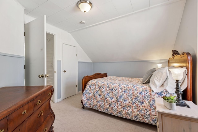 bedroom with light carpet and vaulted ceiling