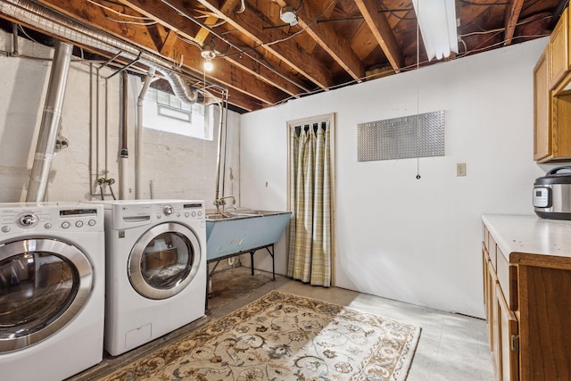 laundry room with laundry area, washer and dryer, and a sink