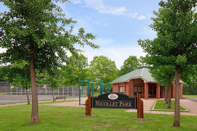 view of property's community featuring a yard and fence