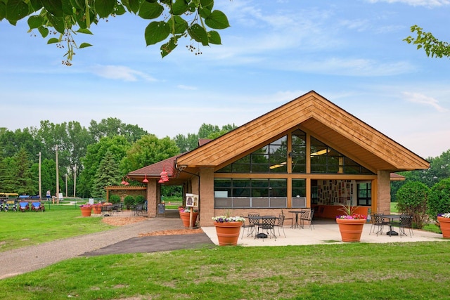 view of home's community featuring a patio and a yard