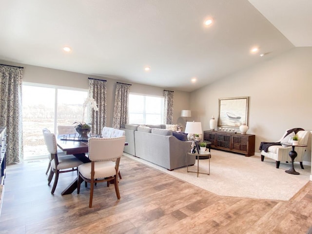 dining space with lofted ceiling, light wood-style flooring, and recessed lighting