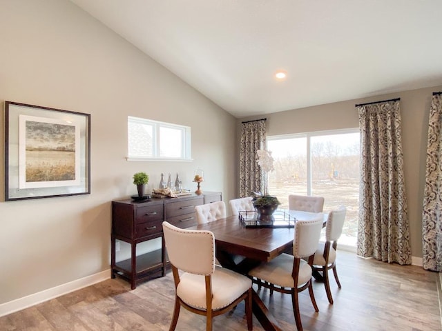 dining area with light wood-type flooring, baseboards, vaulted ceiling, and recessed lighting