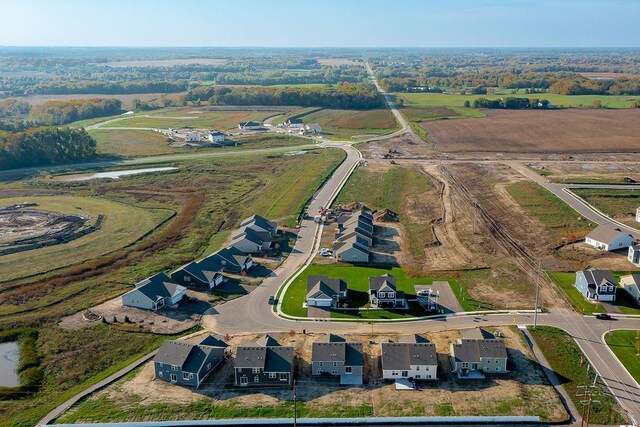 drone / aerial view featuring a residential view and a rural view