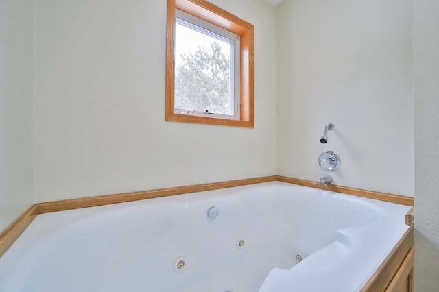 full bathroom with a jetted tub