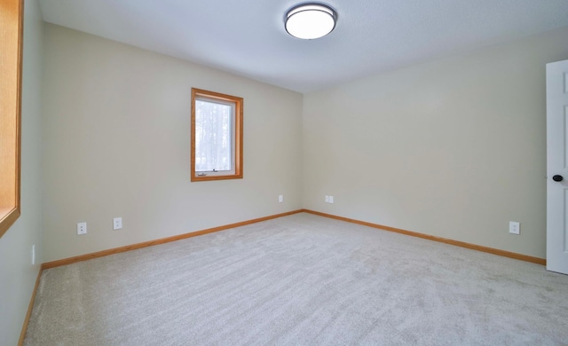 empty room with carpet flooring and baseboards