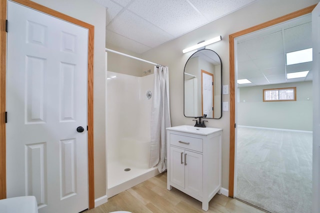 full bath with curtained shower, a paneled ceiling, and vanity