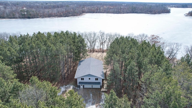 birds eye view of property featuring a wooded view and a water view