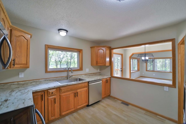 1505 Harrison Dr SW, Brainerd, MN 56401 - kitchen with a sink, stainless steel dishwasher, light wood-style flooring, a textured ceiling, and a chandelier