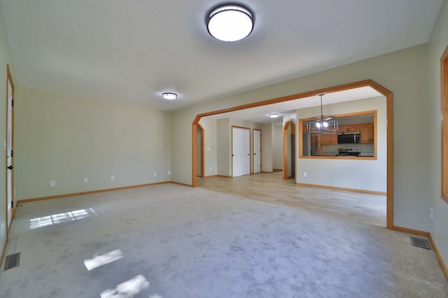 1505 Harrison Dr SW, Brainerd, MN 56401 - unfurnished living room featuring light colored carpet and baseboards
