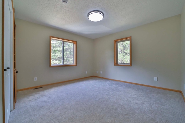 1505 Harrison Dr SW, Brainerd, MN 56401 - spare room featuring carpet flooring, a textured ceiling, baseboards, and a smoke detector