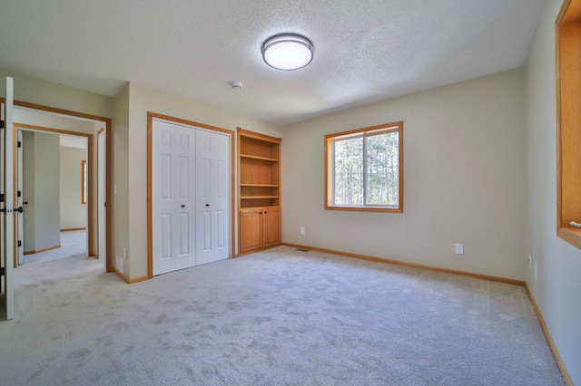 1505 Harrison Dr SW, Brainerd, MN 56401 - unfurnished bedroom with light colored carpet, a textured ceiling, baseboards, and a closet