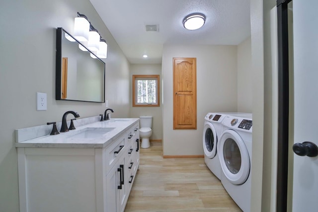 1505 Harrison Dr SW, Brainerd, MN 56401 - laundry area with independent washer and dryer, light wood-style floors, and baseboards