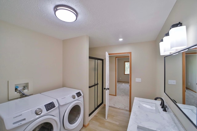 1505 Harrison Dr SW, Brainerd, MN 56401 - laundry area featuring light wood-style flooring, washing machine and dryer, a textured ceiling, and recessed lighting