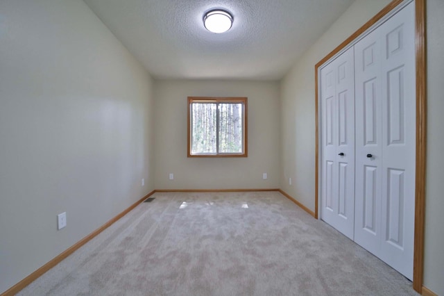 1505 Harrison Dr SW, Brainerd, MN 56401 - unfurnished bedroom featuring a textured ceiling, baseboards, a closet, and carpet