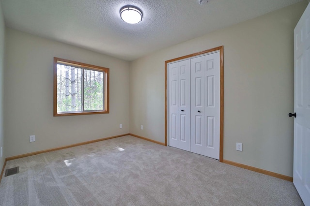 1505 Harrison Dr SW, Brainerd, MN 56401 - unfurnished bedroom featuring a textured ceiling, carpet flooring, a closet, and baseboards
