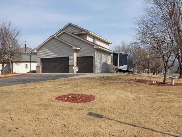 view of side of home featuring driveway, an attached garage, and brick siding