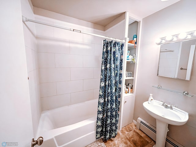 bathroom with shower / tub combo, baseboard heating, and a sink