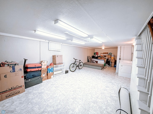 finished basement featuring a textured ceiling, washer / dryer, and tile patterned floors