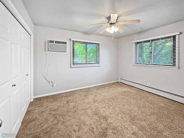 2815 9th St N Unit B4, Fargo, ND 58102 - unfurnished bedroom featuring an AC wall unit, baseboard heating, a closet, and multiple windows