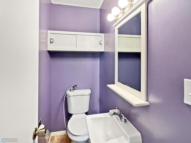2815 9th St N Unit B4, Fargo, ND 58102 - half bathroom featuring toilet and a sink