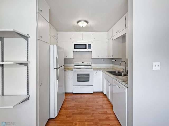 2815 9th St N Unit B4, Fargo, ND 58102 - kitchen featuring white appliances, a sink, light wood-style flooring, and light countertops