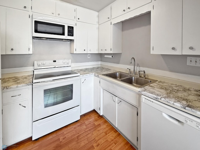 2815 9th St N Unit B4, Fargo, ND 58102 - kitchen featuring white appliances, a sink, light countertops, light wood finished floors, and white cabinets