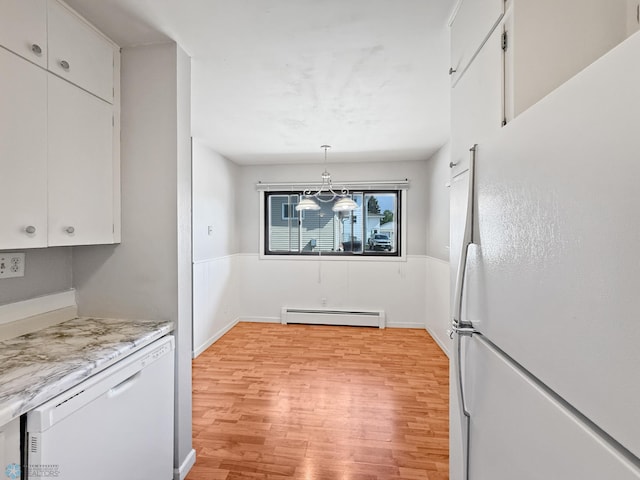 2815 9th St N Unit B4, Fargo, ND 58102 - unfurnished dining area with a baseboard radiator, light wood-style floors, and baseboards