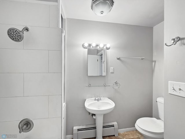 2815 9th St N Unit B4, Fargo, ND 58102 - bathroom featuring a baseboard radiator, toilet, baseboards, and a shower