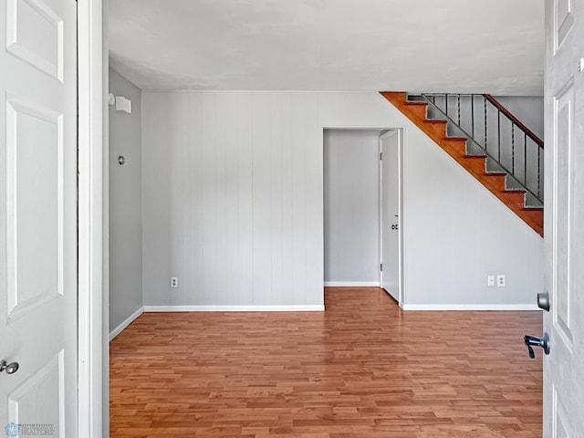 2815 9th St N Unit B4, Fargo, ND 58102 - spare room with wood finished floors, baseboards, and stairway