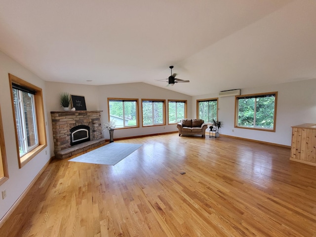 13857 Jacob Ave, Nininger Twp, MN 55033 - unfurnished living room with ceiling fan, light wood-style flooring, a fireplace, an AC wall unit, and vaulted ceiling