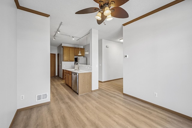 kitchen featuring visible vents, dishwasher, light countertops, light wood-style floors, and a sink