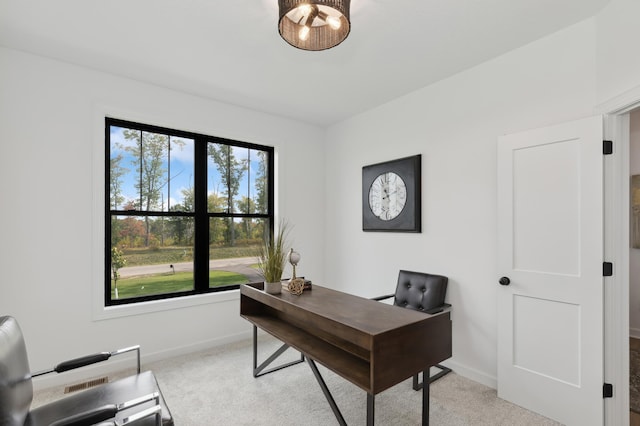 office featuring baseboards and light carpet